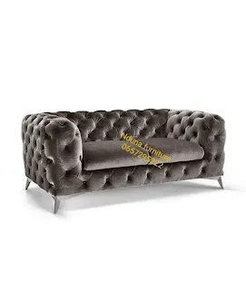 Grey deep-buttoned sofa on chrome legs