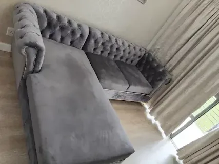 Grey deep-buttoned chaise sectional