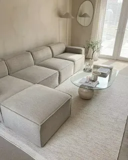 Light neutral sectional couch in a modern lounge